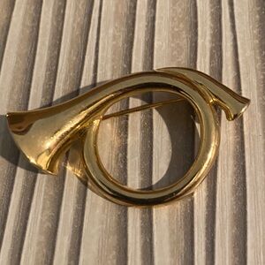 Vintage gold-tone French horn brooch pin.